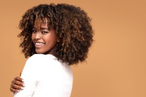 Beautiful African American afro woman with curly hair smiling.