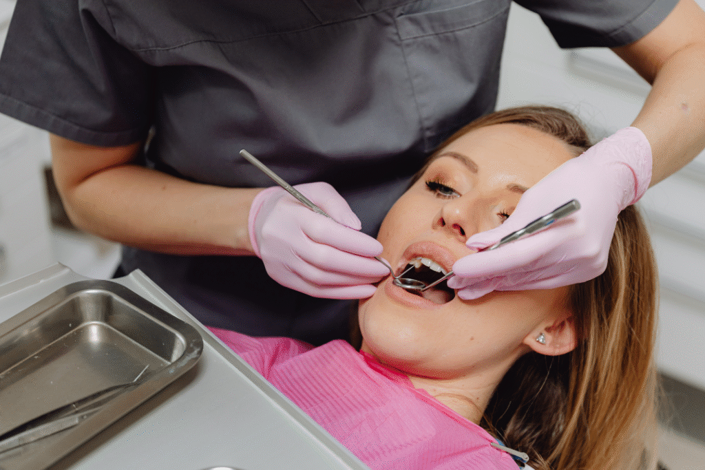 Dentist examining teeth, risks of over-preparation during turkey teeth treatment abroad | Smile London